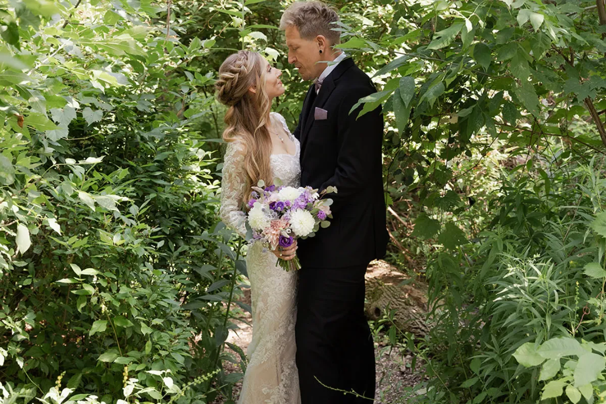 Purple and white wedding flowers from Tina ceremony